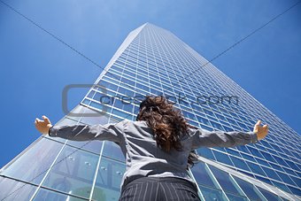businesswoman adoring crystal skyscraper