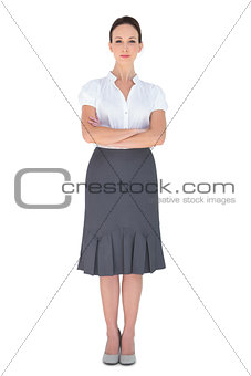 Peaceful businesswoman posing crossing arms