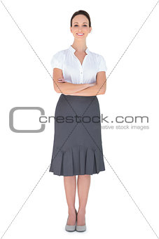 Cheerful businesswoman posing crossing arms