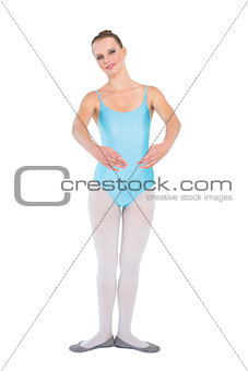 Happy pretty ballerina posing looking at camera