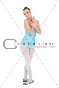 Serious pretty ballerina posing looking at camera