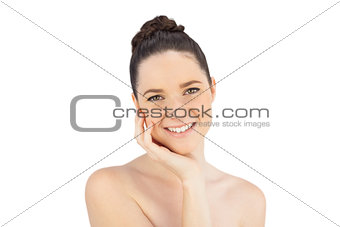 Smiling natural model stroking her face
