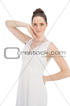 Natural model in white dress posing stroking her face