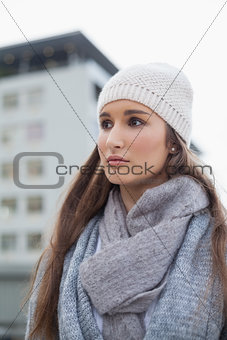 Thoughtful gorgeous woman with winter clothes on posing