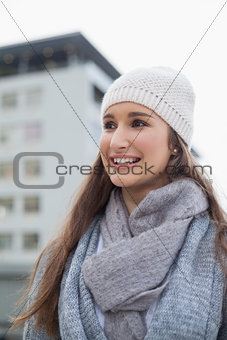 Smiling gorgeous woman with winter clothes on posing