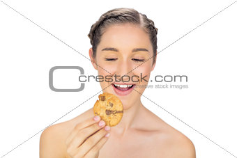 Greedy young model holding cookie