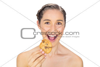 Greedy smiling model holding cookie