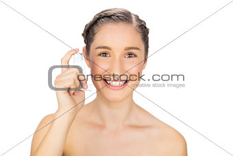 Smiling young model holding asthma atomizer