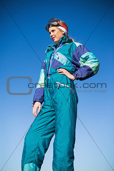 Woman in ski suit with one hand on hip