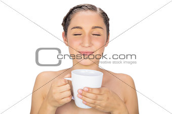 Relaxed natural model smelling flavoured coffee