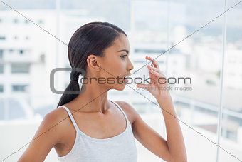 Pretty model using her asthma atomizer
