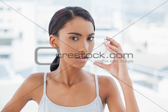 Serious model using her asthma atomizer