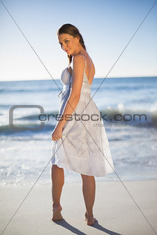 Peaceful attractive woman looking over shoulder at camera