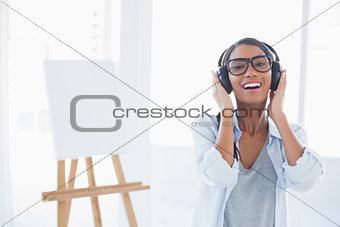 Smiling attractive artist listening to music