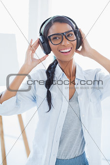 Happy attractive artist listening to music