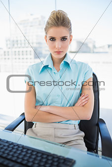 Serious classy businesswoman crossing arms