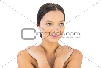 Cheerful woman crossing arms over shoulders