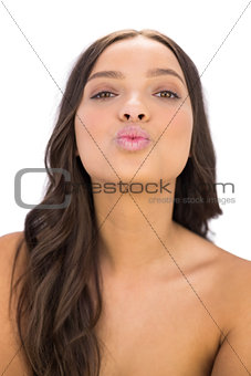Attractive woman blowing an air kiss