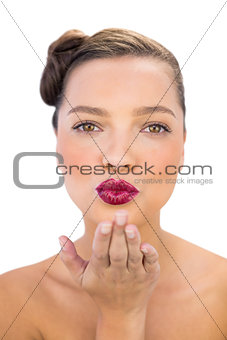 Attractive woman with red lips blowing air kiss