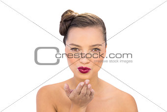 Pretty gorgeous woman with red lips blowing air kiss