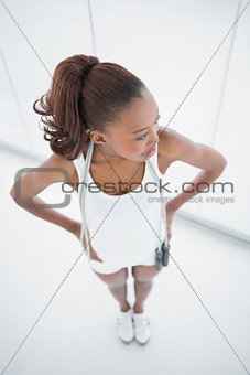 Relaxed fit woman holding skipping rope on shoulders