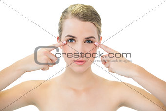 Pretty blonde pointing at her crows feet
