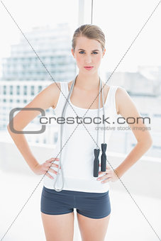 Motivated sporty woman holding skipping rope