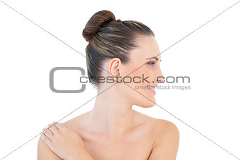 Smiling woman looking aside with hand on shoulder