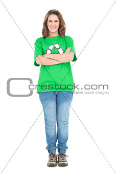 Woman wearing green tshirt with recycling symbol crossing arms