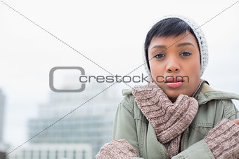 Cute young model in winter clothes shivering