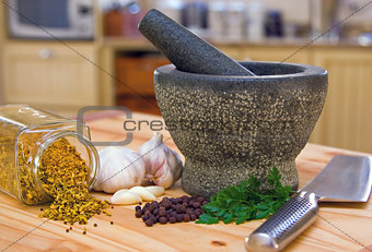 Kitchen scene showing a pestle and mortar and spices