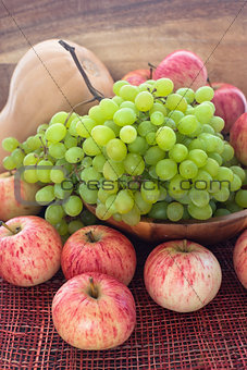 Autumnal ripe fruits and veg - green grape, red apples and pumpk