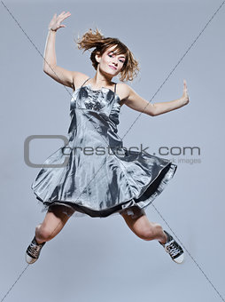 beautiful young girl with prom dress jumping happy