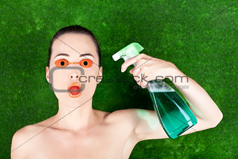 Woman wearing tanning bed glasses with strawberry in mouth and s