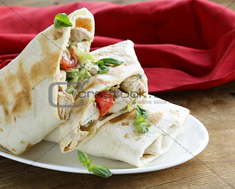 burrito (doner) with chicken and vegetables wrapped in pita bread