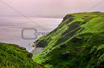 Ocean coastline with green cliffs in Scottish highlands