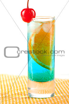Alcohol cocktail with blue curacao, orange and maraschino
