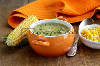soup of fresh yellow corn served on a wooden table