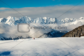 Panoramic View on Mountains and Two People Walking in French Alp