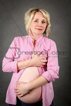 beautiful pregnant woman tenderly holding her tummy