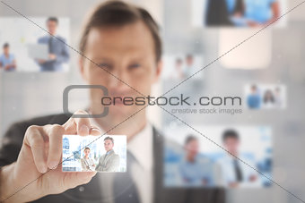Pleased businessman picking a picture