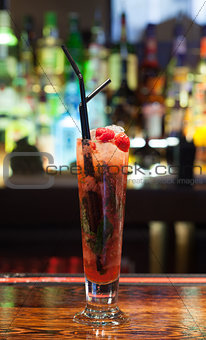 Close up on colourful cocktail with strawberries on the edge