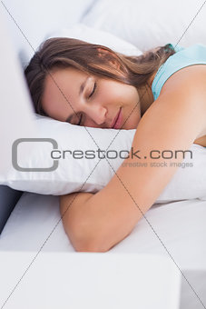 Attractive brunette sleeping peacefully in bed