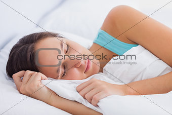 Beautiful brunette sleeping peacefully in bed