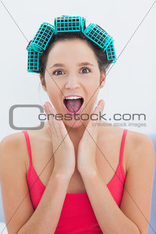 Girl wearing hair rollers looking at camera
