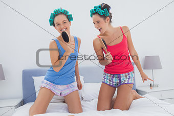 Girls having fun wearing pajama and hair rollers