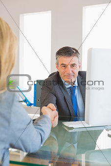 Content businessman shaking the hand of a interviewee
