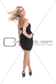 Smiling blonde woman posing looking over shoulder