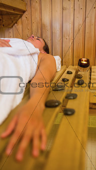 Calm brunette woman lying in a sauna