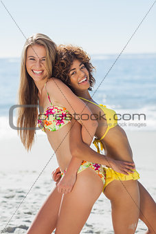 Laughing friends in bikinis having fun